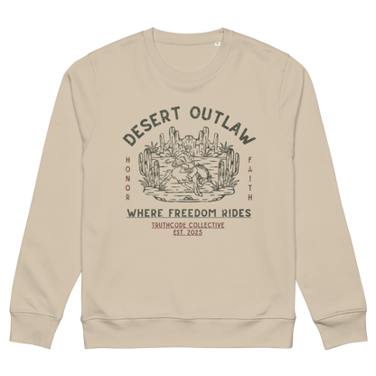 Beige organic sweatshirt with text 'Desert Outlaw, where freedom rides' and scene of cowboy on a bronco in desert graphic design, on a white background