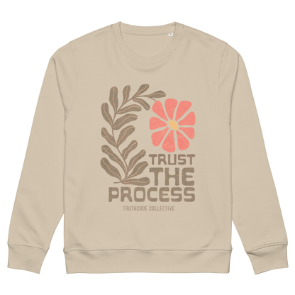 Beige organic sweatshirt with floral design and 'Trust The Process' text on a white background