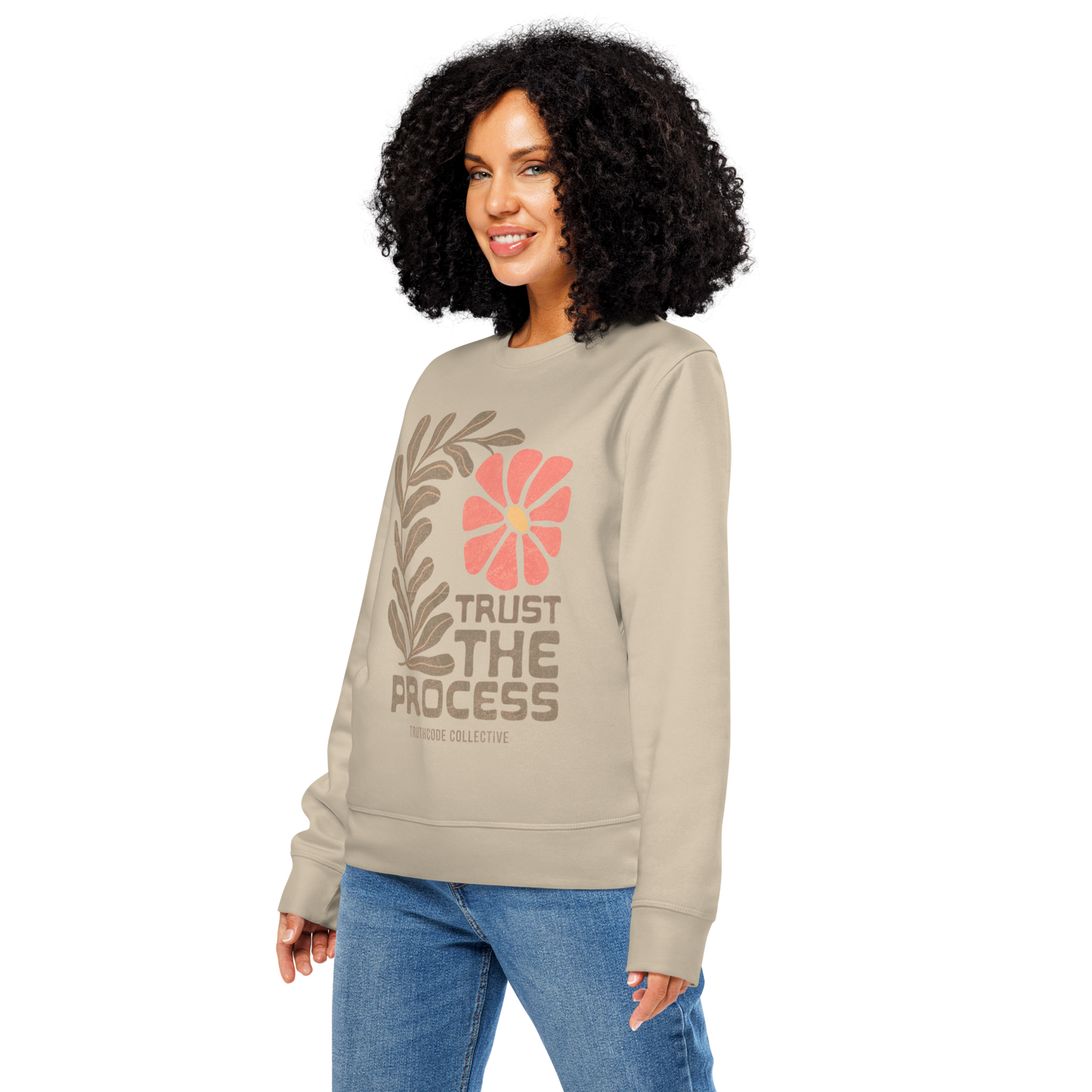 woman wering beige organic sweatshirt with floral design and 'Trust The Process' text 