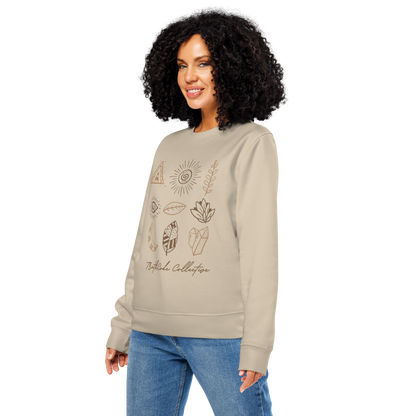 Woman wearing beige organic sweatshirt with graphic designs of mystic markings- symbols of feathers, crystals,  earthy motifs, etc., on a white background