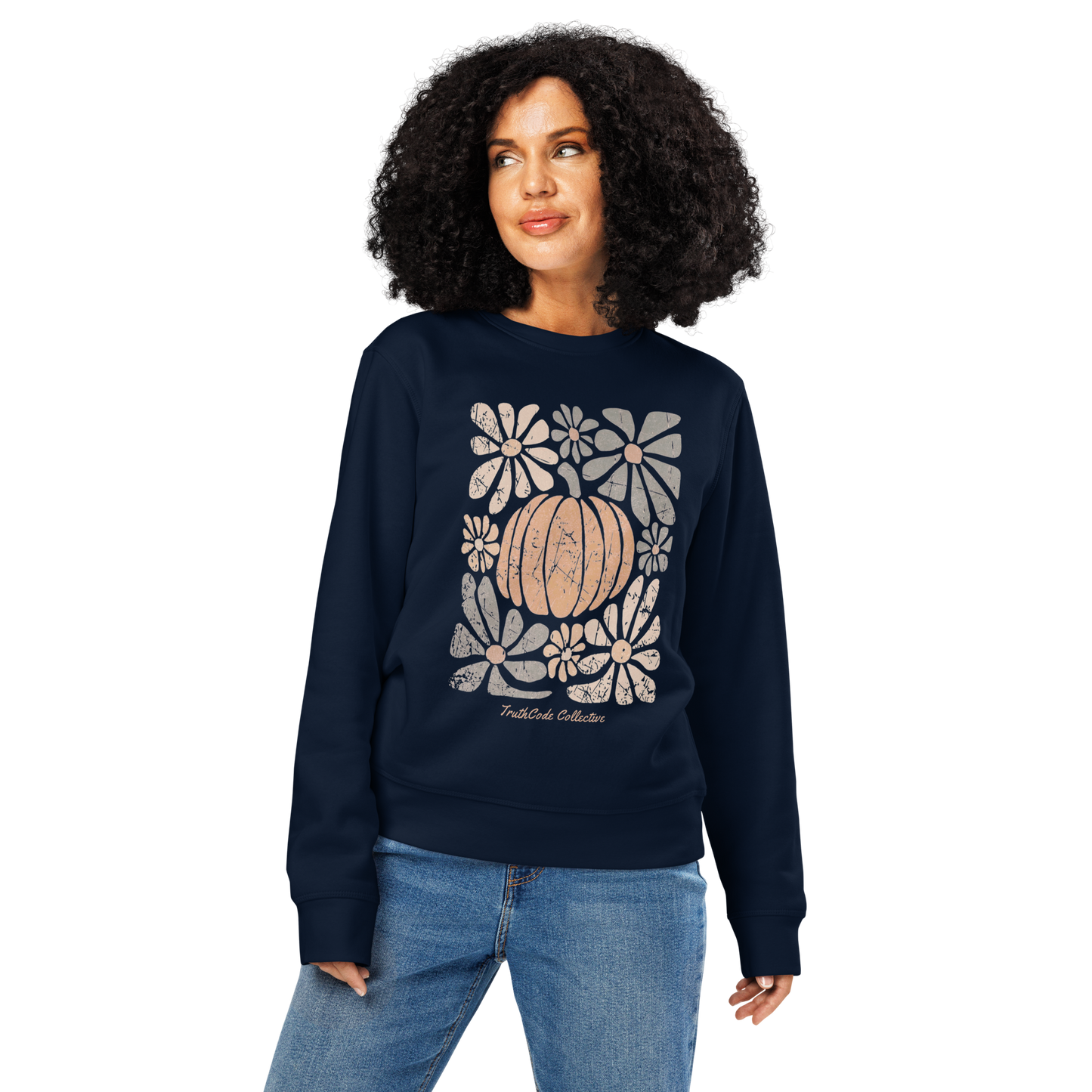 Woman wearing navy blue organic sweatshirt with a pumpkin and floral design on a white background