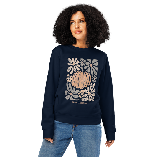 Woman wearing navy blue organic sweatshirt with a pumpkin and floral design on a white background
