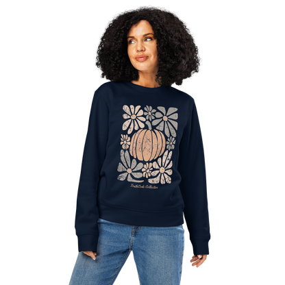 Woman wearing navy blue organic sweatshirt with a pumpkin and floral design on a white background