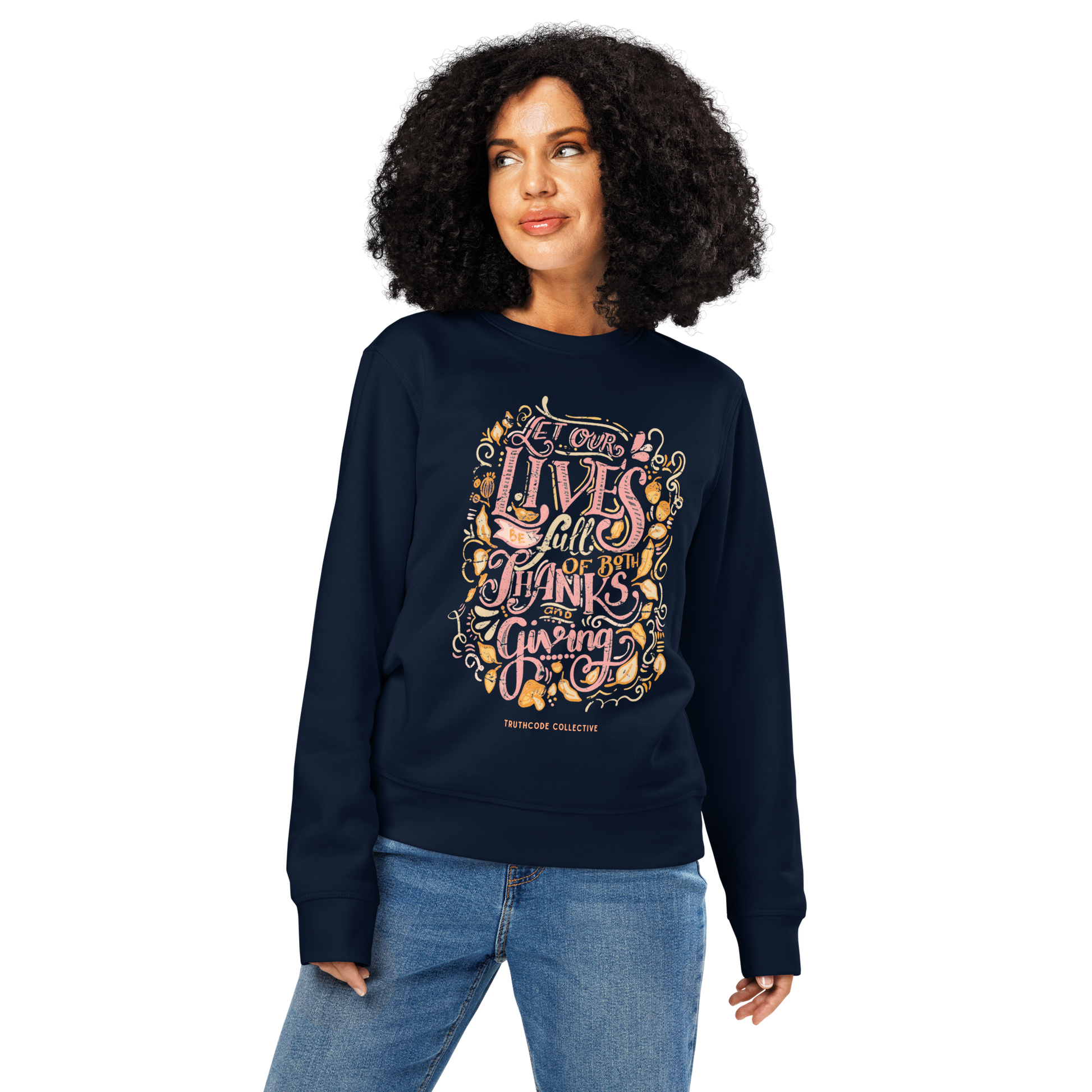 Woman wearing navy blue organic sweatshirt with colorful text design 'Let our lives be full of both thanks and giving' on a white background