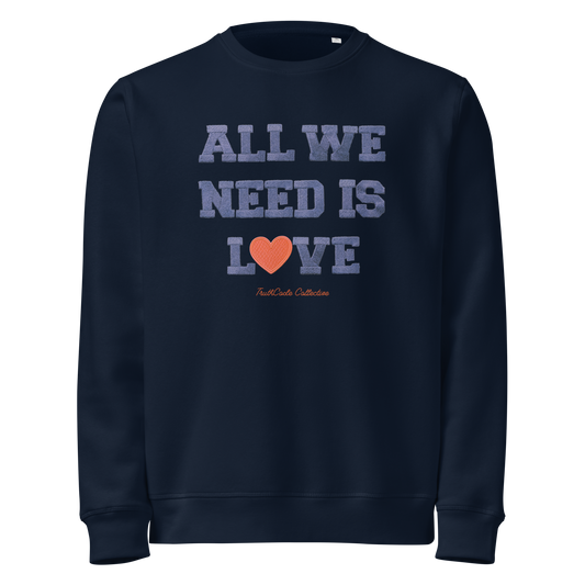 Navy blue organic sweatshirt with 'All We Need Is Love' text on a white background