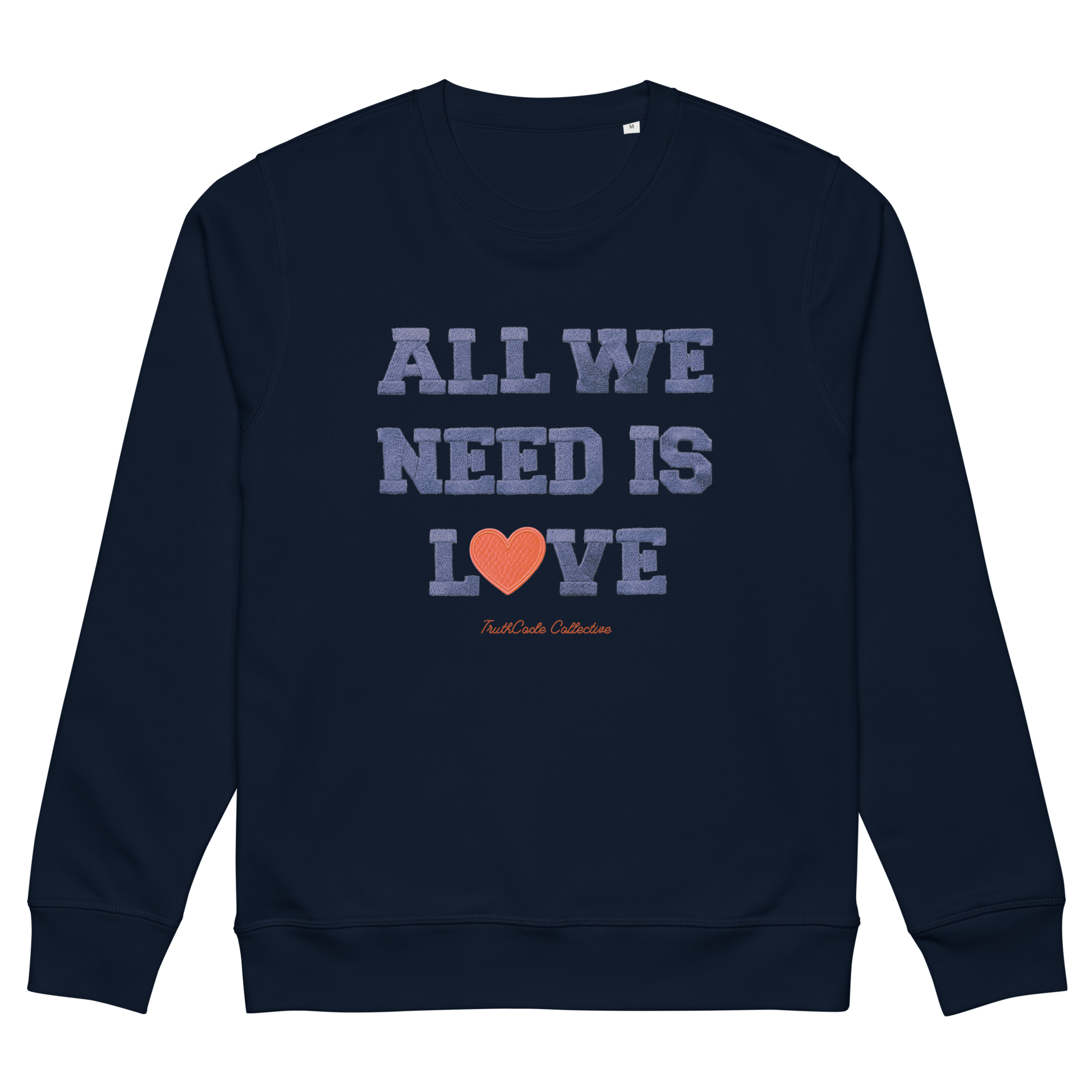 Navy blue organic sweatshirt with 'All We Need Is Love' text and heart graphic on a white background