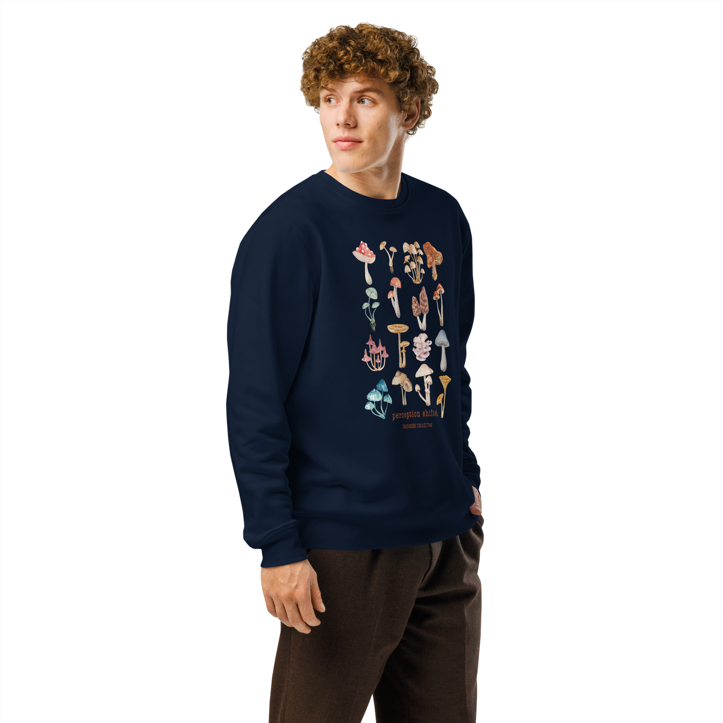 Guy wearing navy blue organic sweatshirt with colorful mushroom illustrations and text 'Perception shifted' on a white background