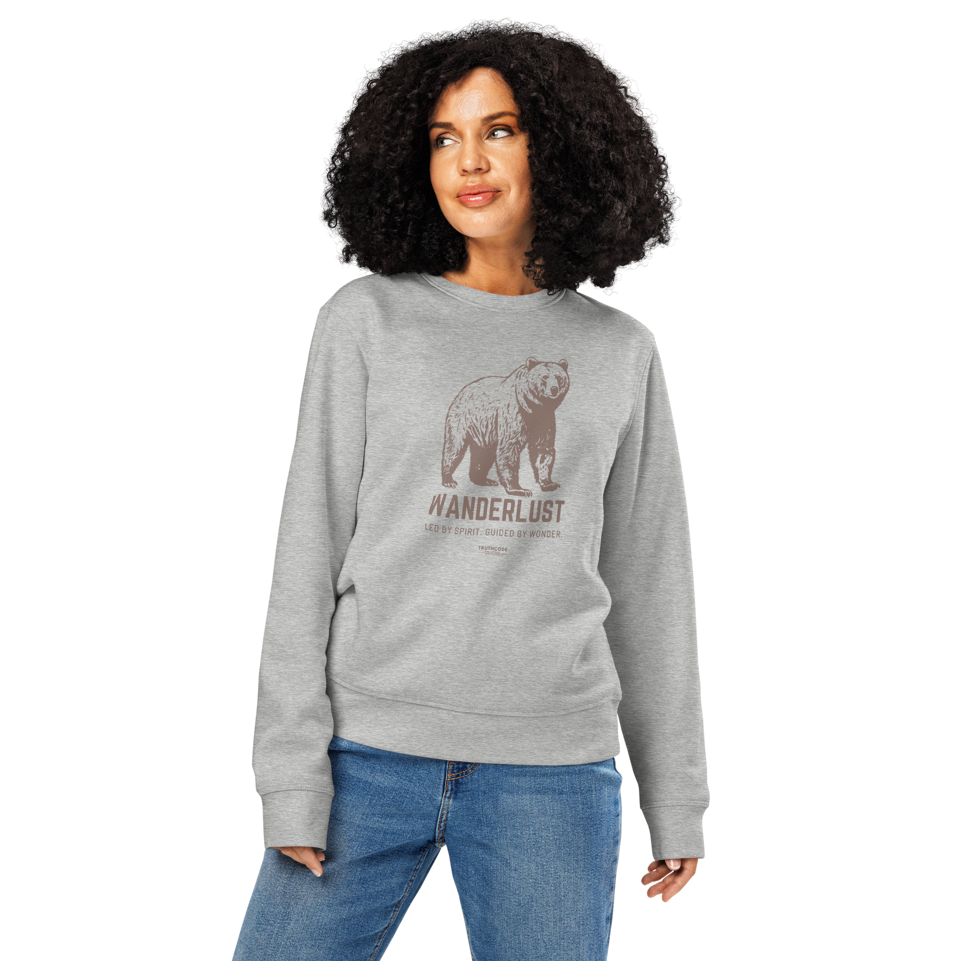 Woman wearing gray organic sweatshirt with bear graphic and 'Wanderlust' text on a white background