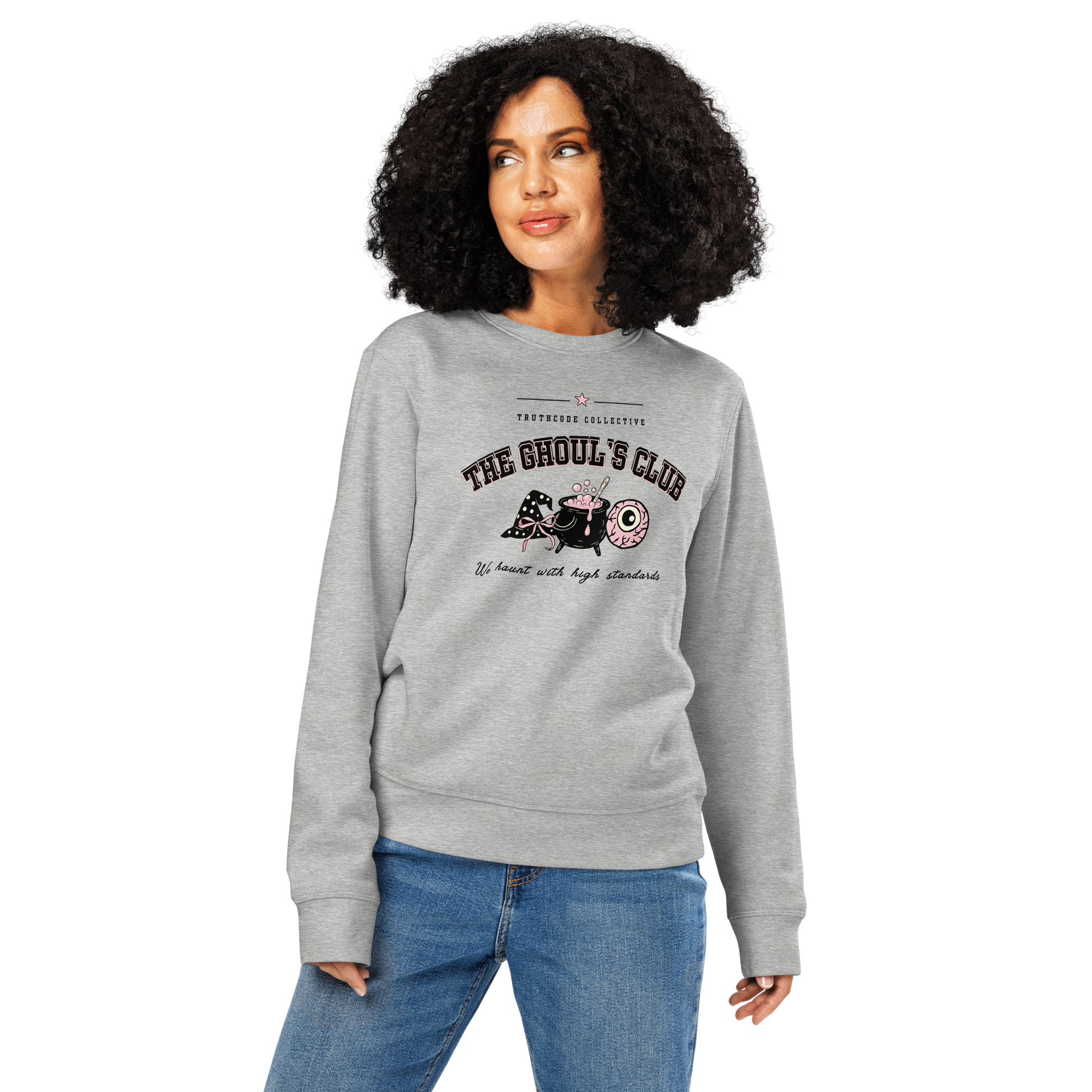 Woman wearing gray organic sweatshirt with 'The Ghoul's Club, we haunt you with high standards' text and halloween style graphic design on a white background