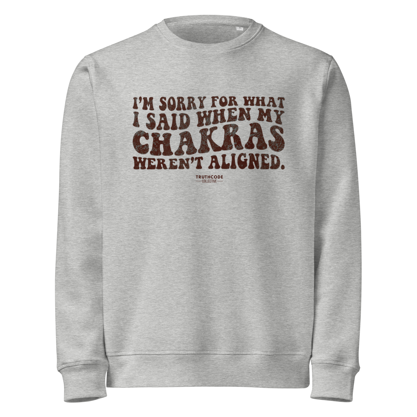 Gray organic sweatshirt with brown text 'I'm sorry for what I said when my chakras weren't aligned' on a white background