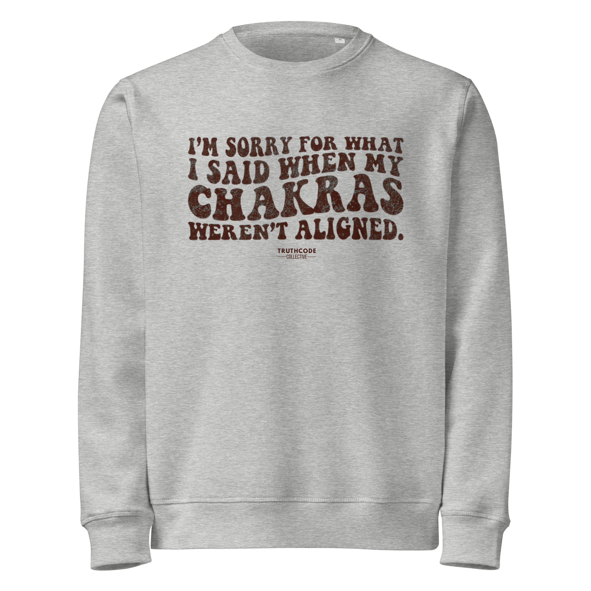 Gray organic sweatshirt with brown text 'I'm sorry for what I said when my chakras weren't aligned' on a white background