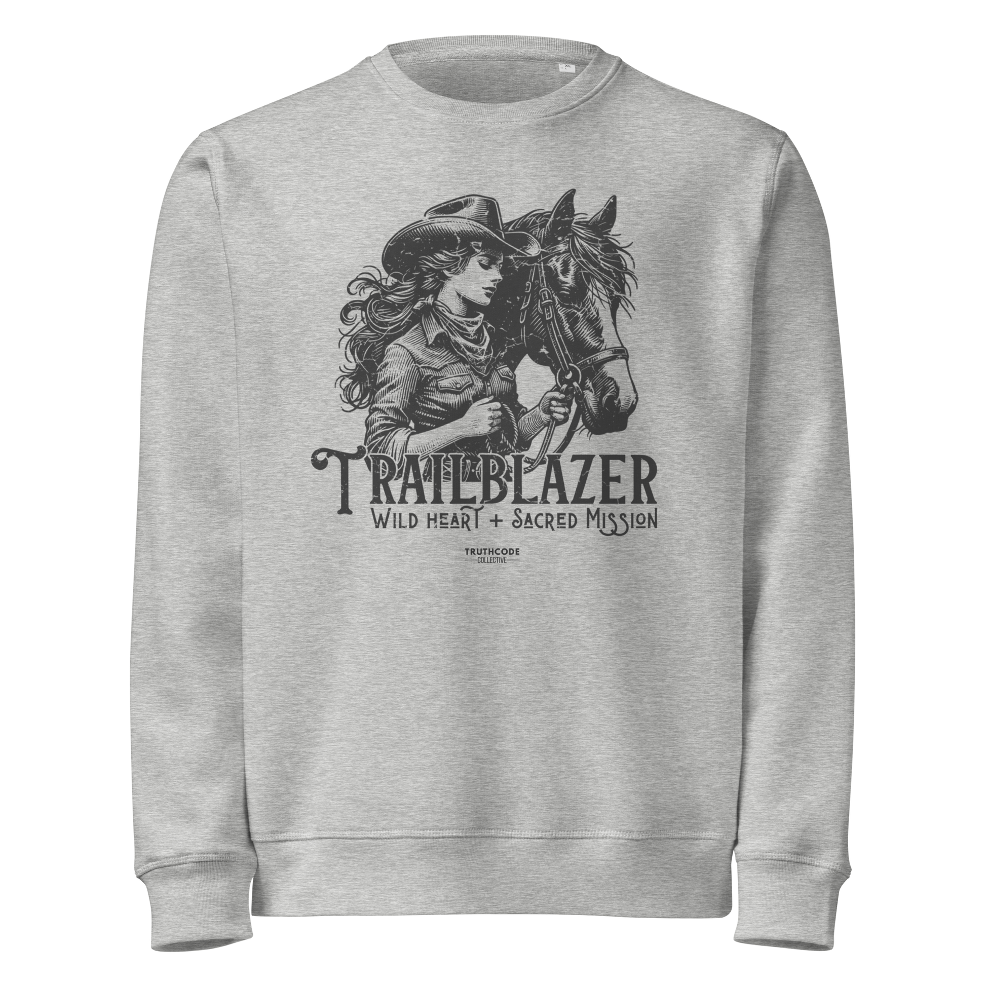 Gray organic sweatshirt with graphic of a woman holding a horse and text 'Trailblazer' and 'Wild heart, sacred mission' on a white background