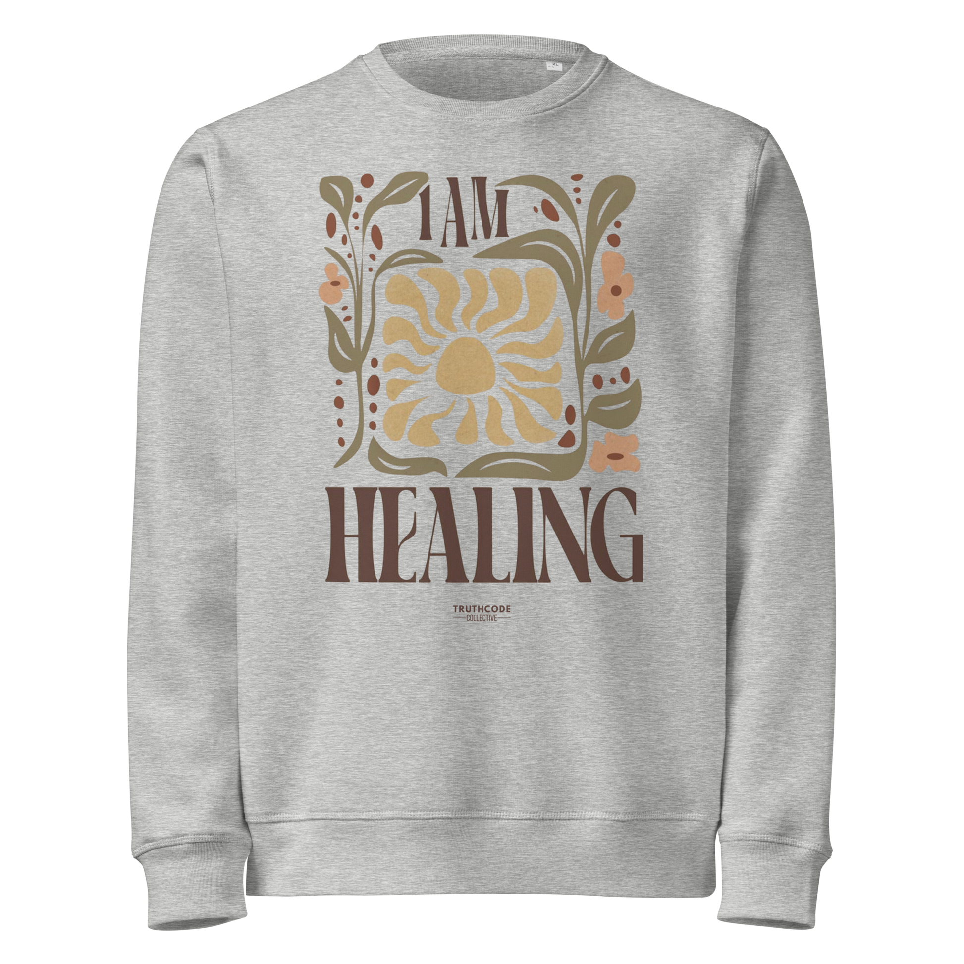 Gray organic sweatshirt with 'I AM HEALING' text and sun and plants design on a white background