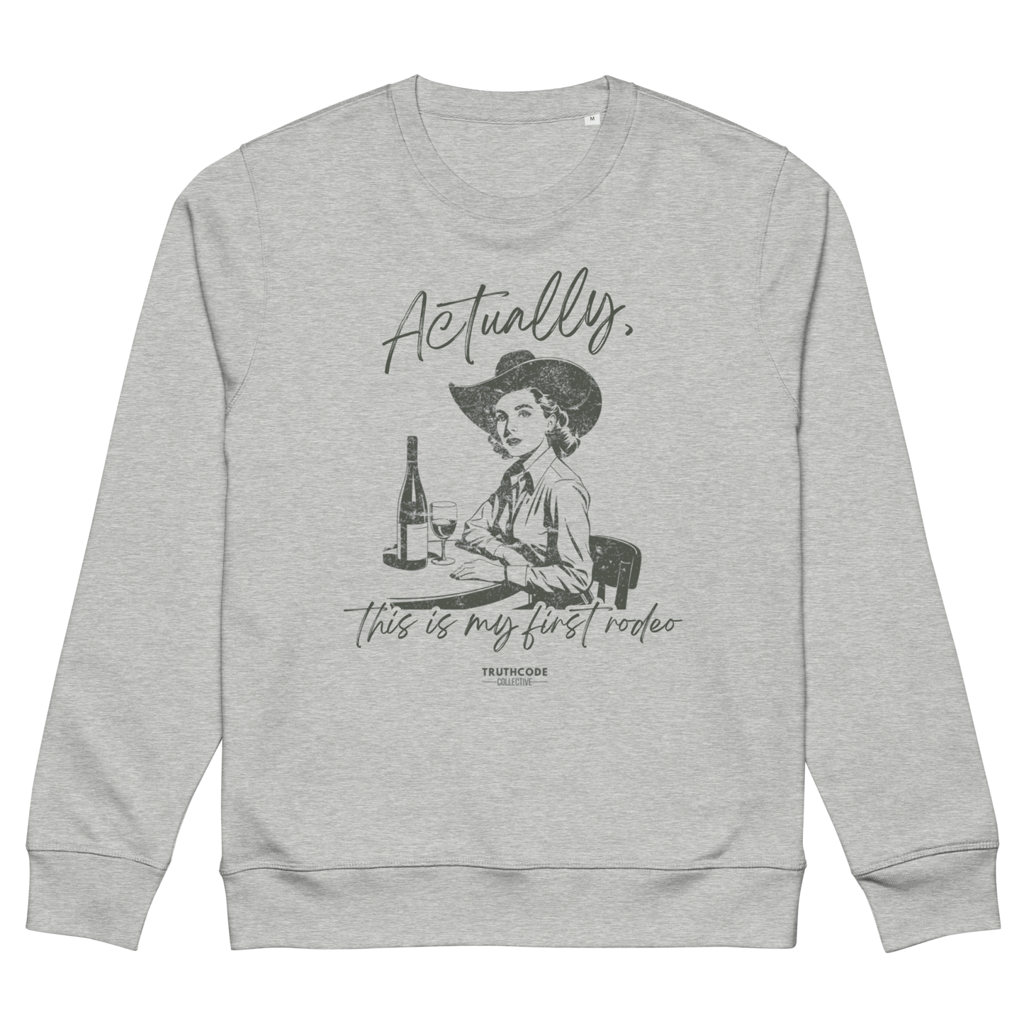 Gray organic sweatshirt with a vintage style graphic of a woman in a cowboy hat and text 'Actually, this is my first rodeo' on a white background