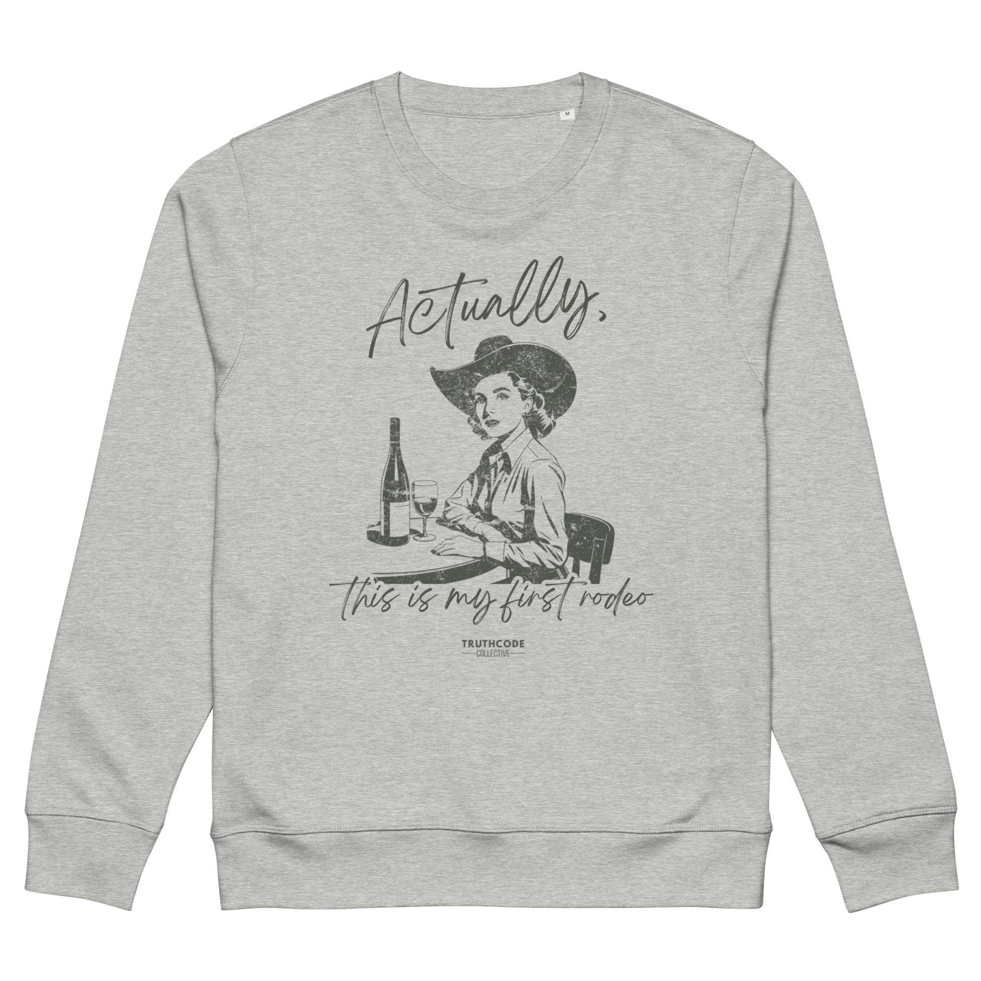 Gray organic sweatshirt with a vintage style graphic of a woman in a cowboy hat and text 'Actually, this is my first rodeo' on a white background