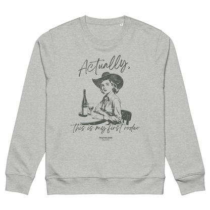Gray organic sweatshirt with a vintage style graphic of a woman in a cowboy hat and text 'Actually, this is my first rodeo' on a white background