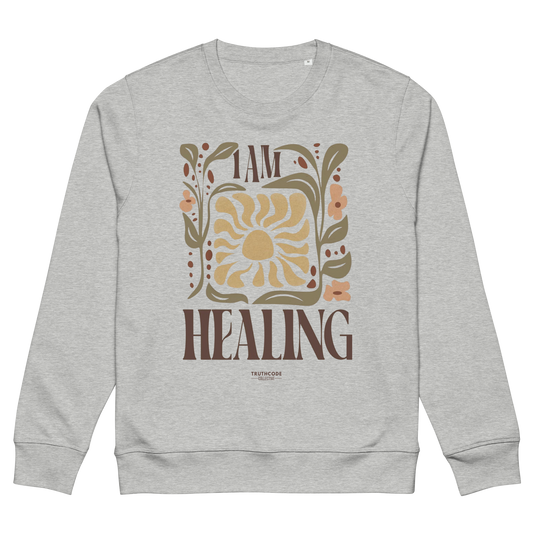 Gray organic sweatshirt with 'I AM HEALING' text and floral design on a white background