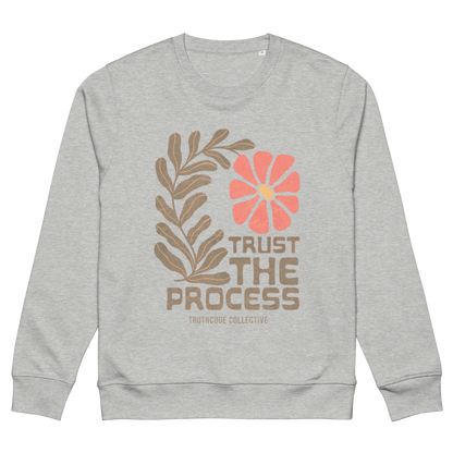 Gray organic sweatshirt with floral design and 'Trust The Process' text on a white background