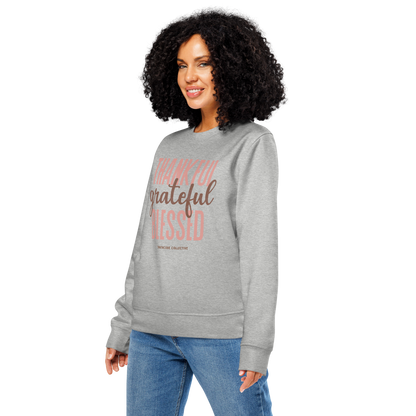 Woman wearing gray organic sweatshirt with 'Thankful grateful BLESSED' text design on a white background