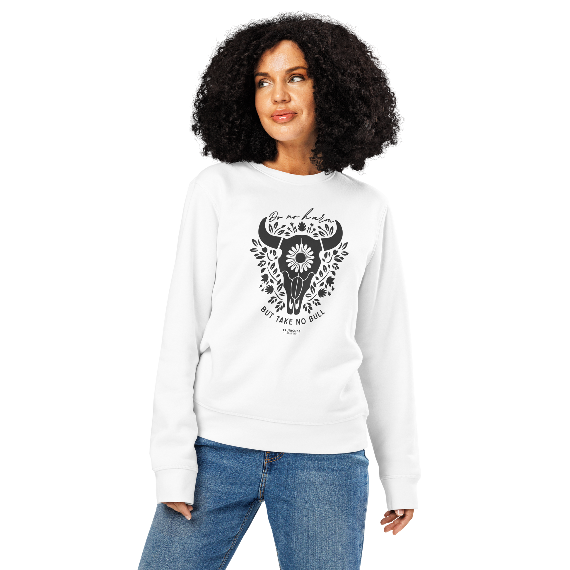 Woman wearing white organic sweatshirt with bull skull and floral design and text 'Do no harm, but take no bull' on a white background