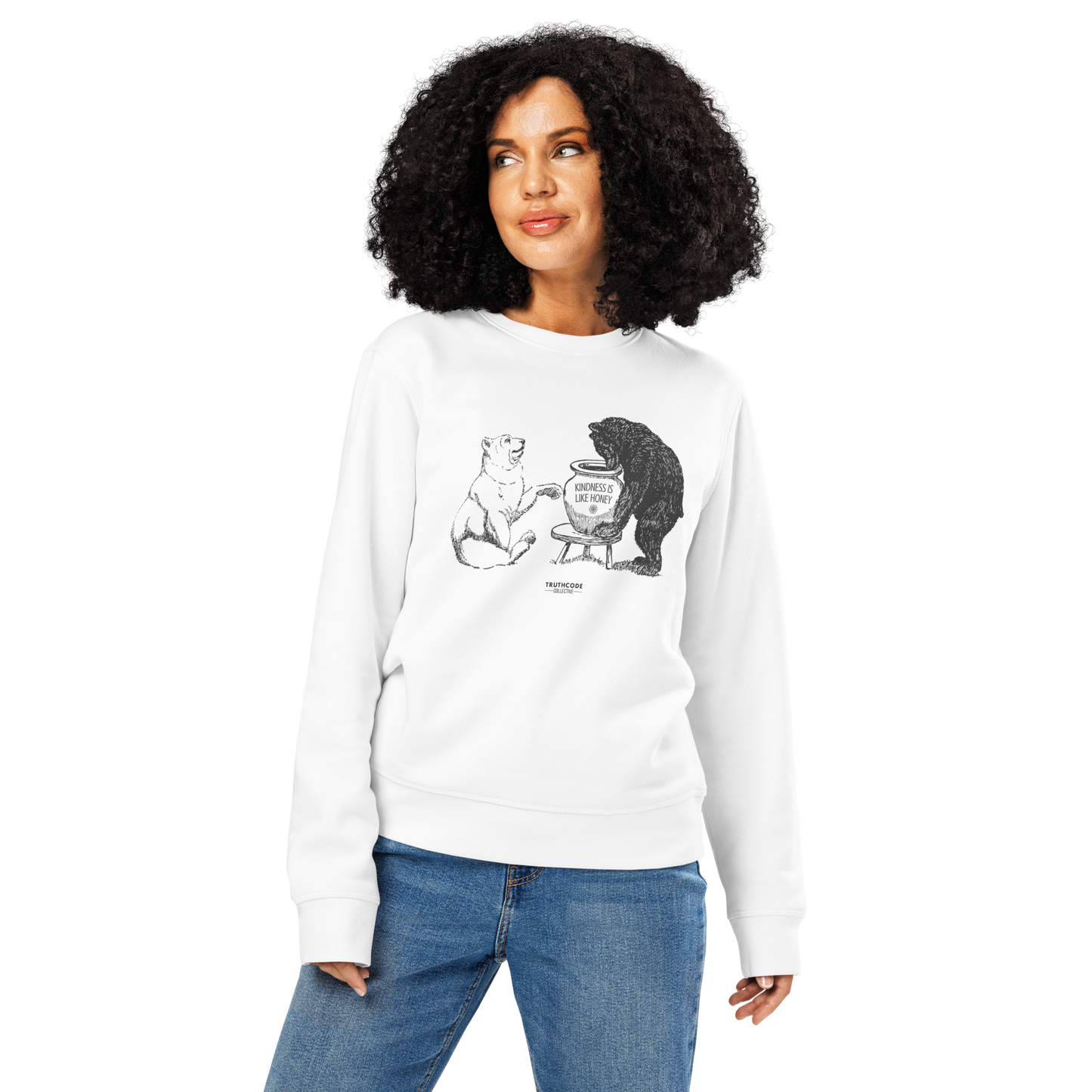 Woman wearing white organic sweatshirt with bears eating honey graphic and text 'Kindness is like honey' on a white background