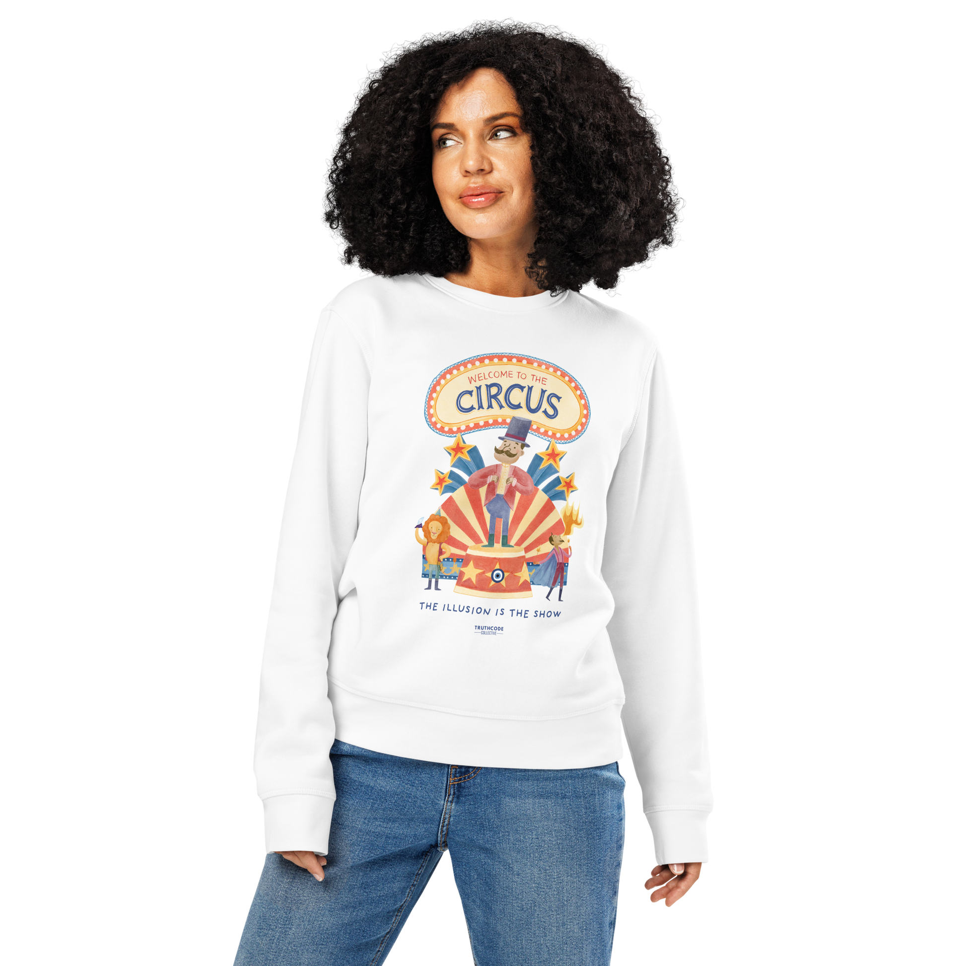 Woman wearing white organic sweatshirt with circus-themed graphic design and text 'Welcome to the circus' and 'The illusion is the show' on a white background