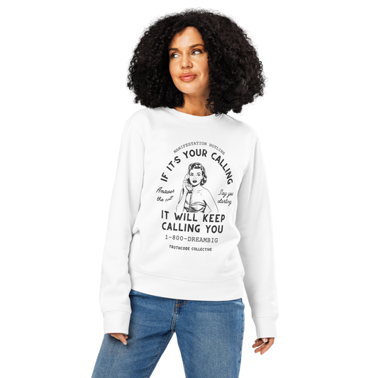 Woman wearing white organic sweatshirt with vintage-style graphic of a woman on the phone and text 'If it's your calling, it will keep calling you' and '1-800-DREAMBIG' on a white background