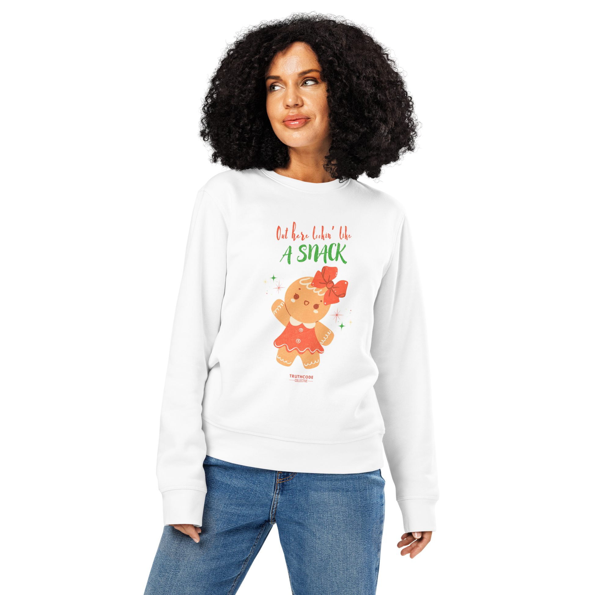 Woman wearing white organic sweatshirt with a gingerbread girl graphic and text 'Out here lookin' like a snack' on a white background