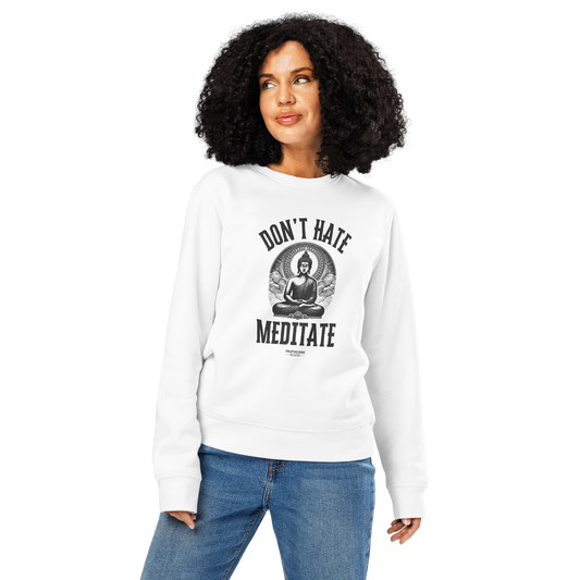 Woman wearing white organic sweatshirt with Buddha graphic and text 'Don't Hate Meditate' on a white background