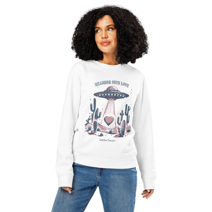 Woman wearing white organic sweatshirt with a UFO and cactus design and text 'Beaming with love', on a white background