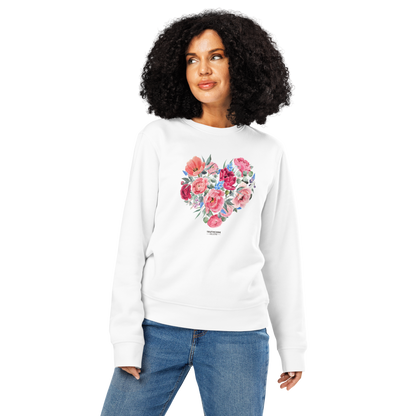 Woman wearing white organic sweatshirt with a floral heart design on a white background
