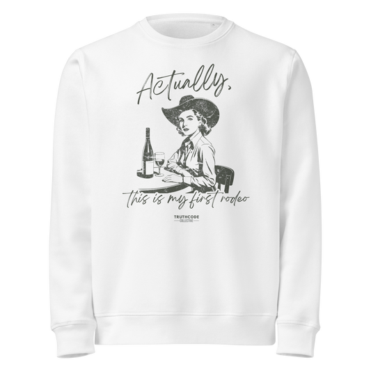 White organic sweatshirt with vintage graphic of a woman in a cowboy hat and text 'Actually, this is my first rodeo' on a white background