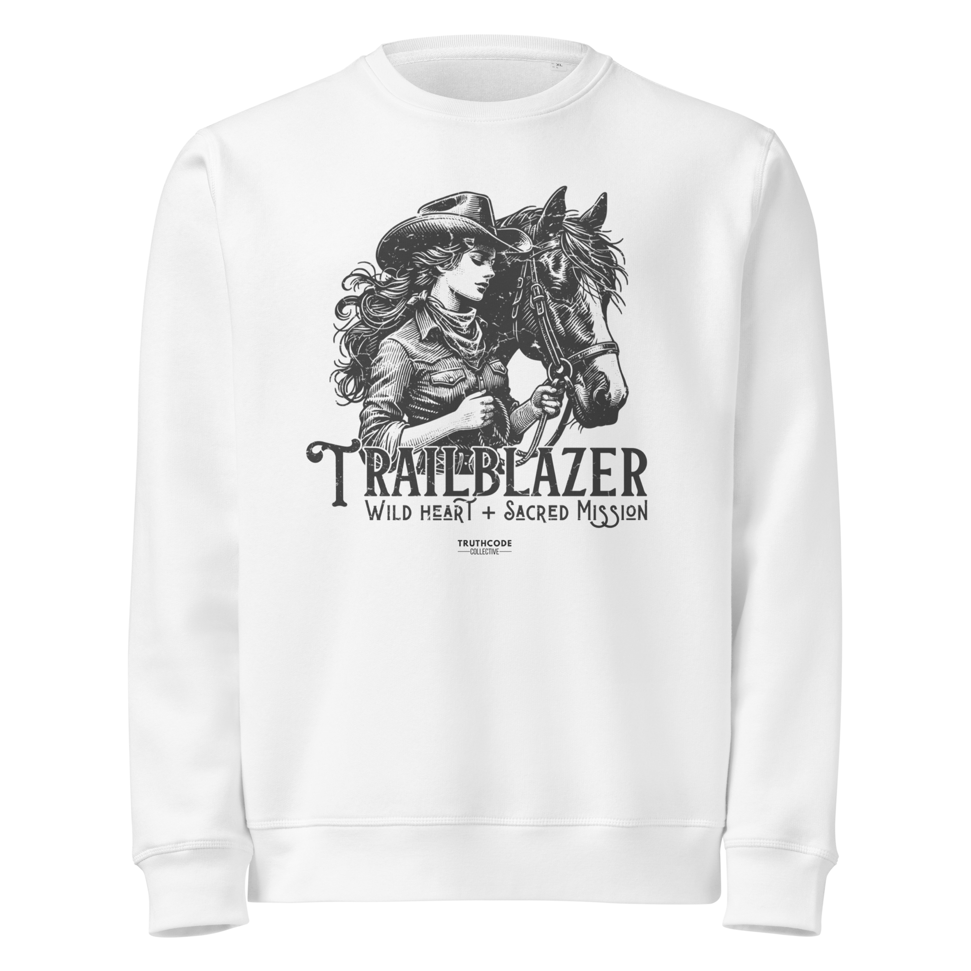 White organic sweatshirt with graphic of a woman holding a horse and text 'Trailblazer' and 'Wild heart, sacred mission' on a white background