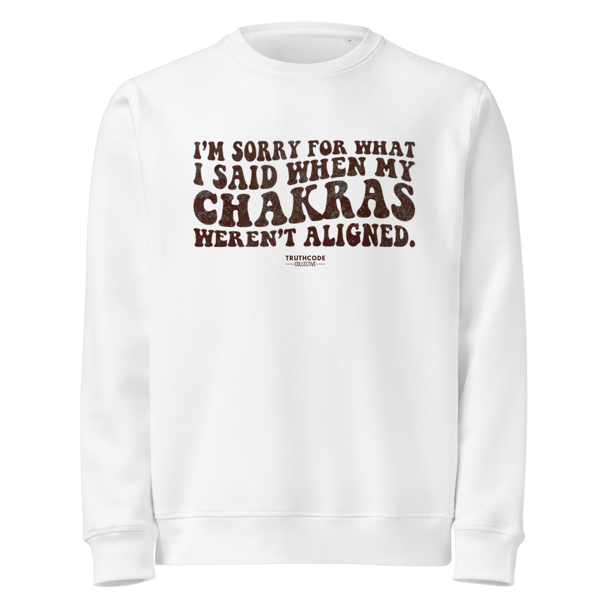 White organic sweatshirt with humorous text 'I'm sorry for what I said when my chakras weren't aligned' on a white background