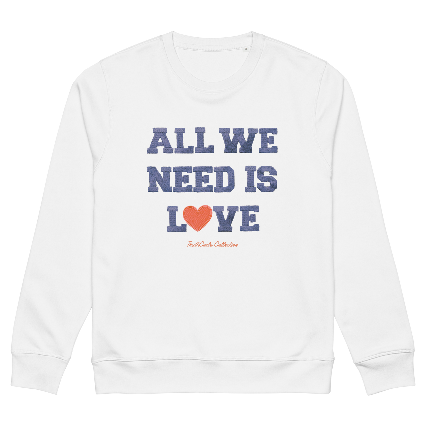 White organic sweatshirt with 'All We Need Is Love' text and heart graphic on a white background