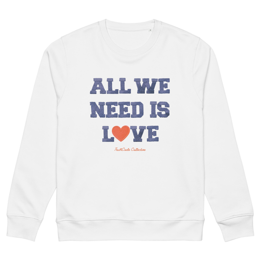 White organic sweatshirt with 'All We Need Is Love' text and heart graphic on a white background