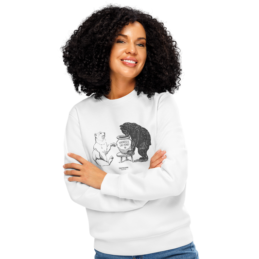 Woman wearing white organic sweatshirt with a graphic of two bears and a honey pot and text 'Kindness is like honey' on a white background