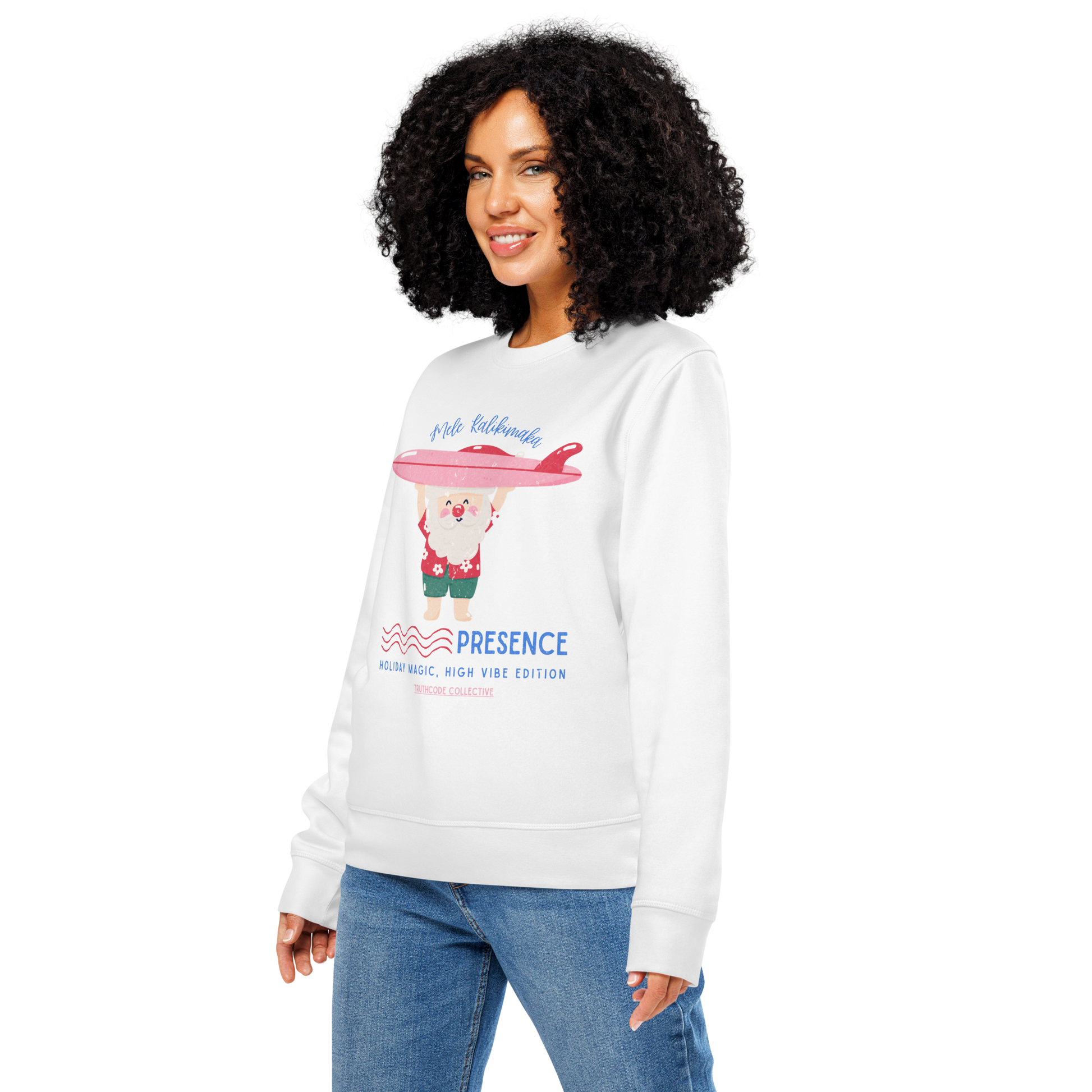Woman wearing white organic sweatshirt with a Santa cartoon holding a surfboard and text 'Mele Kalikimaka' and 'Presence, holiday magic, high vibe edition' on a white background
