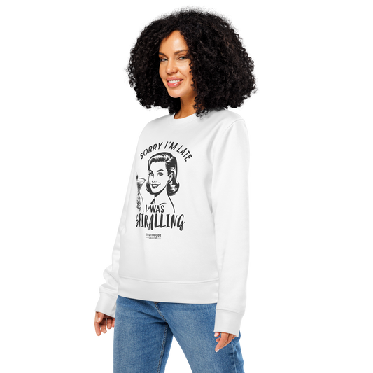 Woman wearing white organic sweatshirt with vintage style graphic design of woman holding a martini glass and text 'Sorry I'm late I was spiraling', on a white background