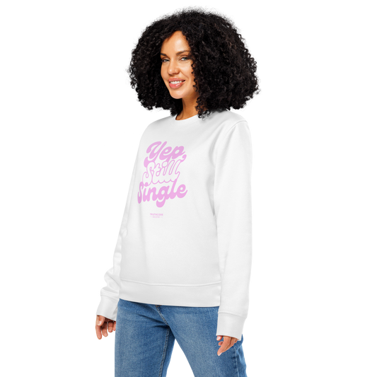 Woman wearing white organic sweatshirt with pink text 'Yep, still single', on a white background