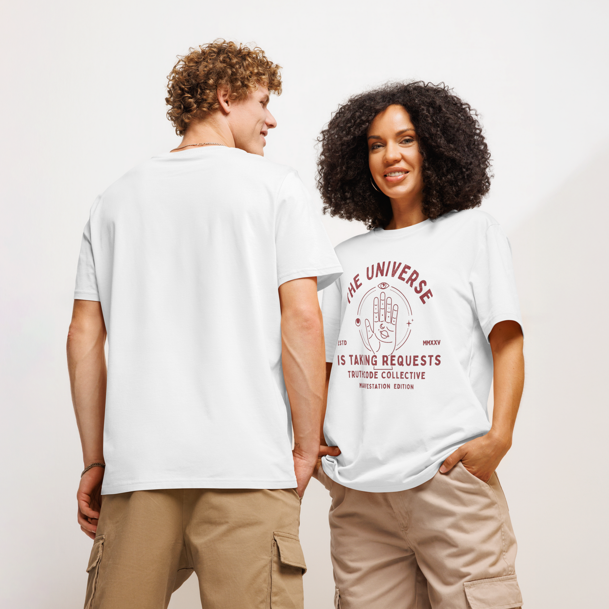 Models wearing white organic t-shirt with graphic of a hand with symbols and text 'The universe is taking requests' against a white background