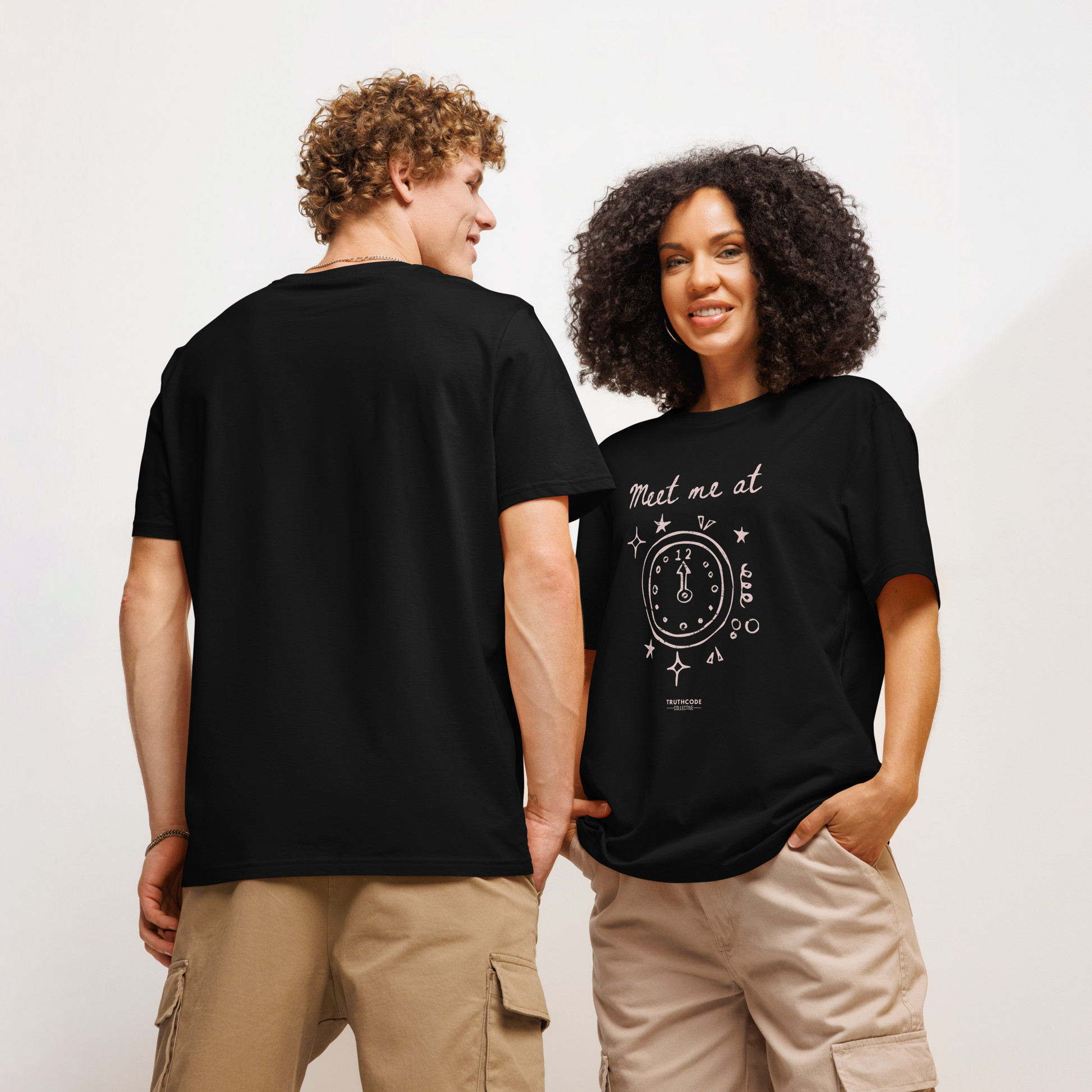 Models wearing black organic t-shirt with a clock design and text 'Meet me at' and clock pointing to midnight, on a white background