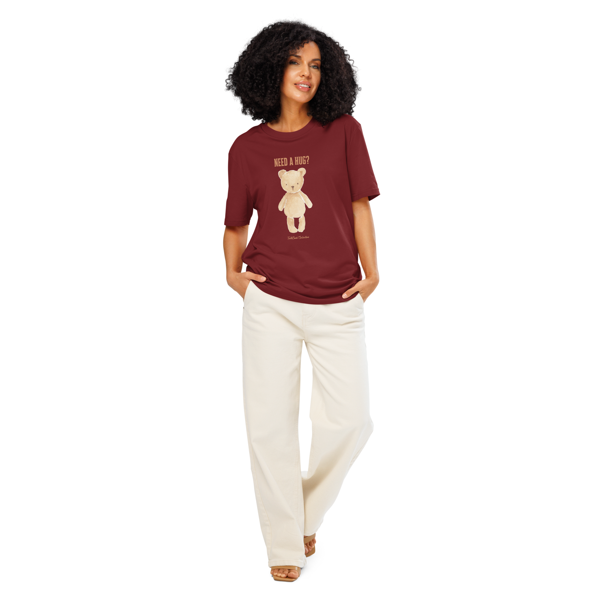 Woman wearing burgundy organic t-shirt with a teddy bear graphic and text 'NEED A HUG?' on a white background
