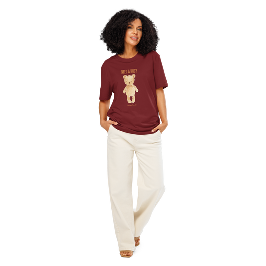Woman wearing burgundy organic t-shirt with a teddy bear graphic and text 'NEED A HUG?', on a white background
