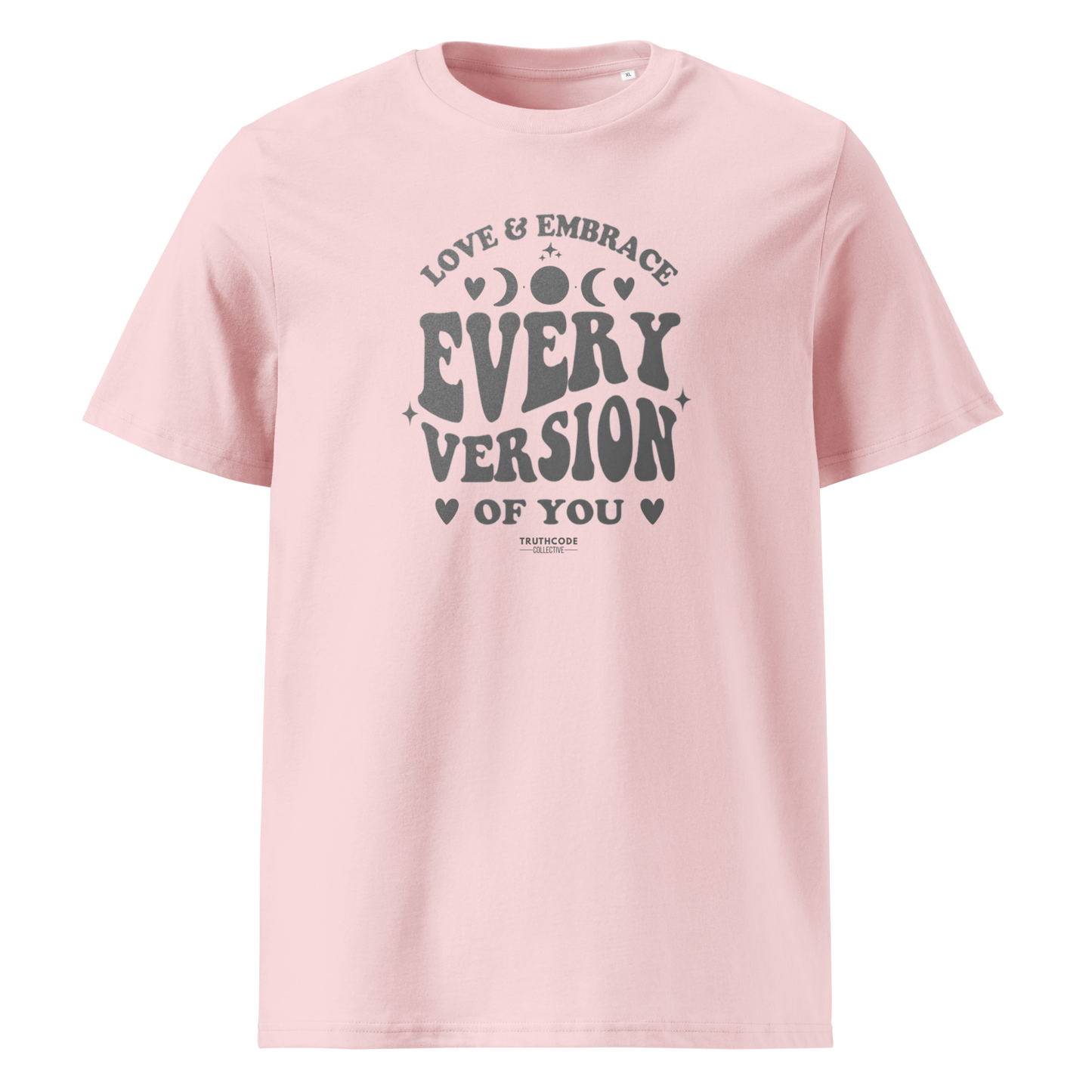 Pink organic t-shirt with motivational text 'Love & embrace every version of you' on a white background