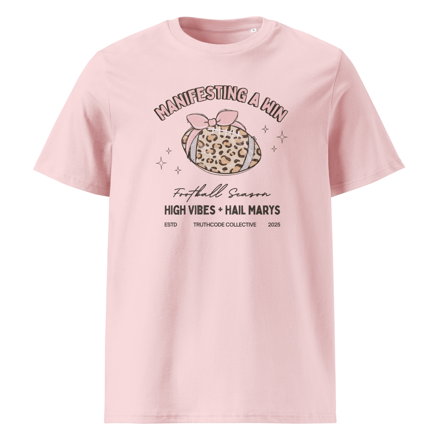Pink organic t-shirt with girly football graphic and text 'Manifesting a win' and 'Football season, high vibes and hail marys' on a white background