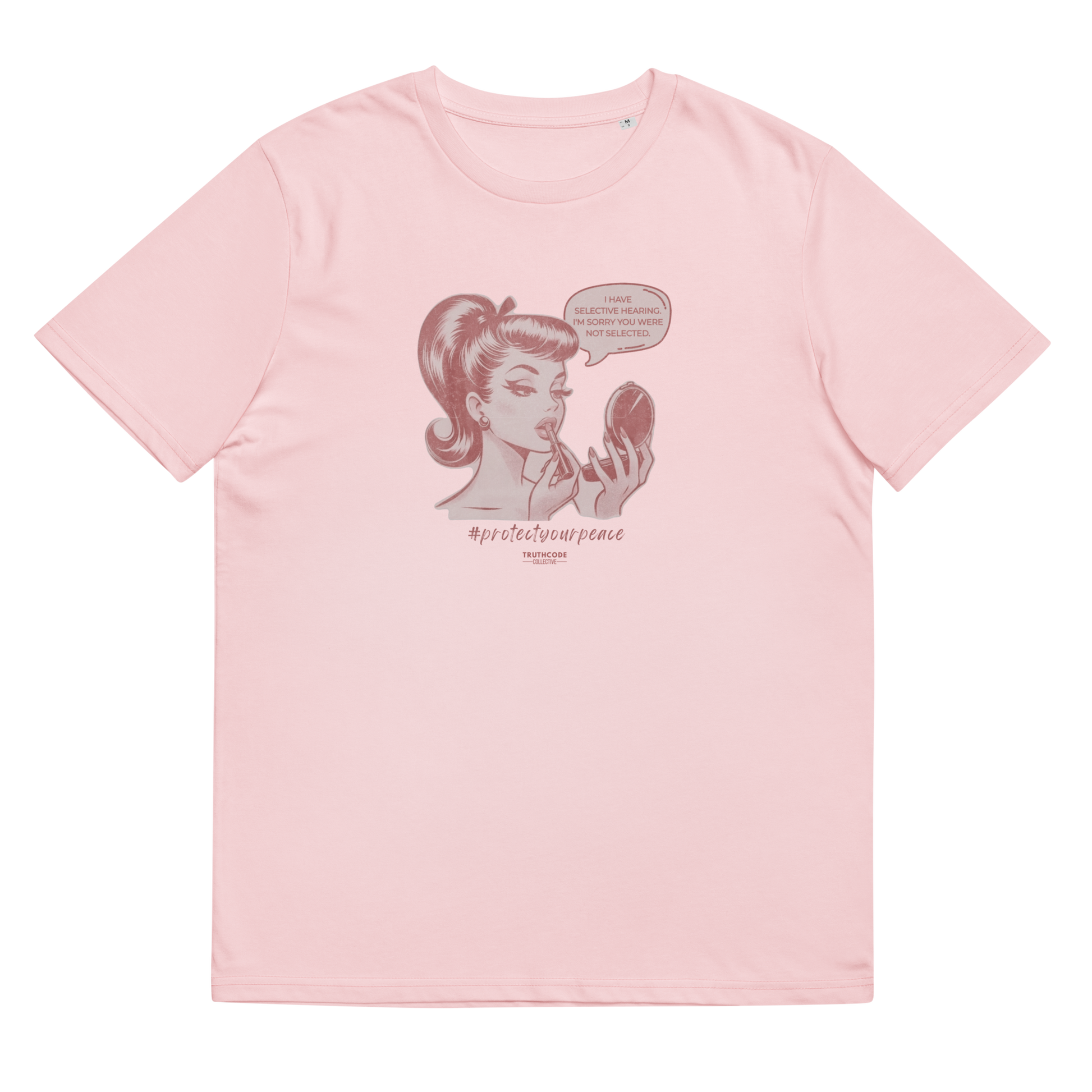 Pink organic t-shirt with a vintage style graphic of a woman looking at herself in a mirror and the text 'I have selective hearing. I'm sorry your were not selected', shirt on a white background