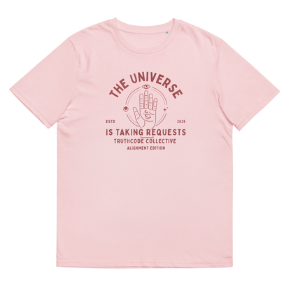Pink organic t-shirt with red graphic and text 'The universe is taking requests' on a white background