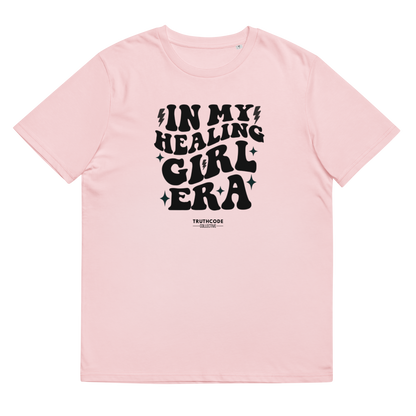 Pink organic t-shirt with black text 'IN MY HEALING GIRL ERA' on a white background