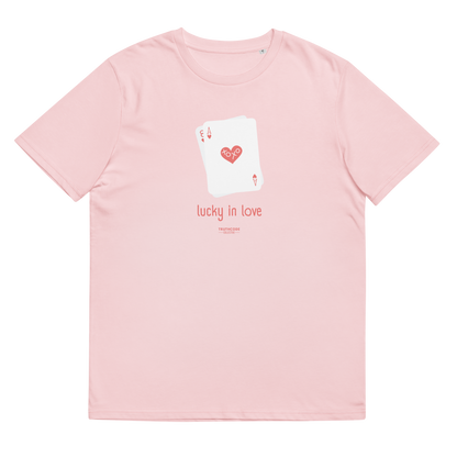 Pink organic t-shirt with a graphic of playing cards and 'lucky in love' text on a white background